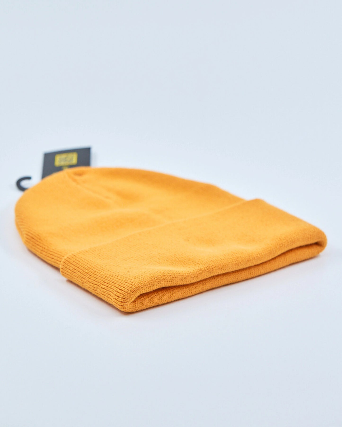 Amber beanie on a light gray background