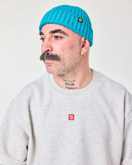 side view of a man wearing Aqua Blue Fisherman Beanie