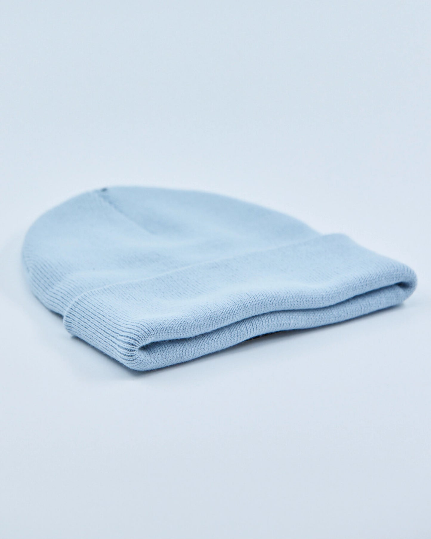 Light blue beanie on a light gray background