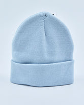 Baby blue beanie on a light gray background