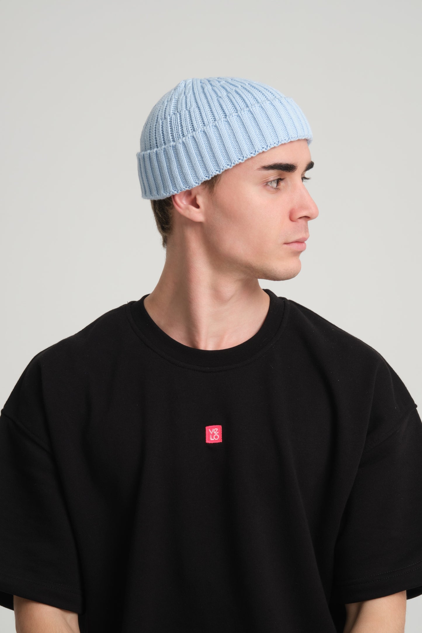 side view of a man wearing Baby Blue Fisherman Beanie