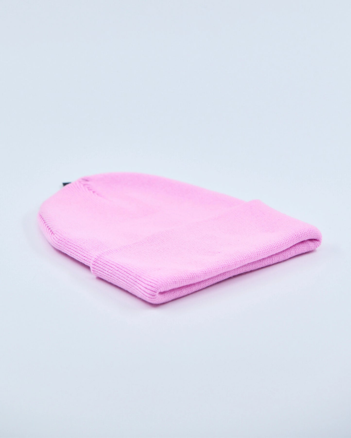 Baby pink beanie on a light gray background