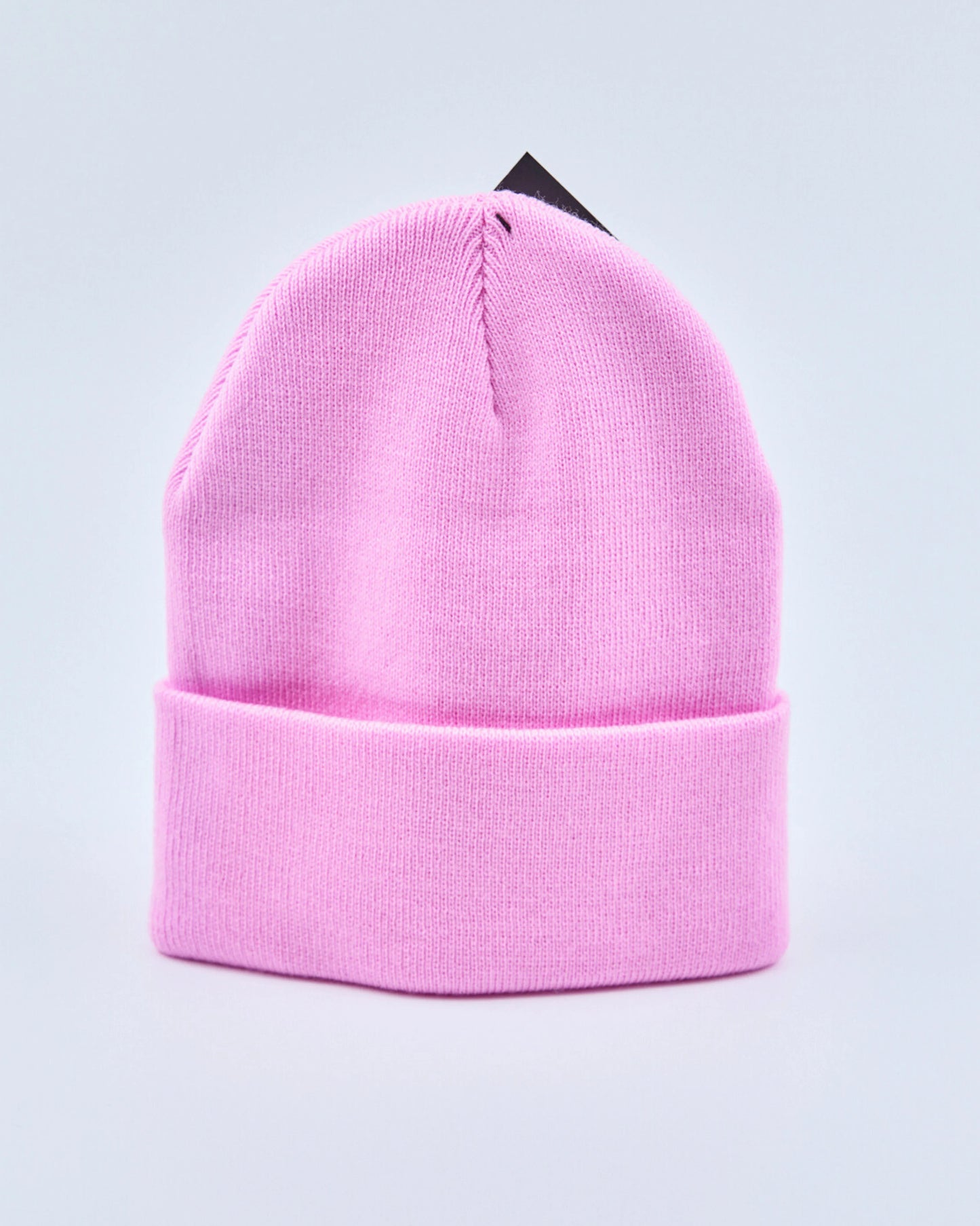 Baby pink beanie on a light gray background