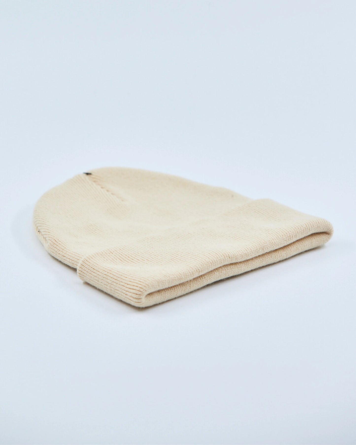 Beige beanie on a light gray background