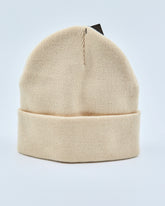 Beige beanie on a light gray background
