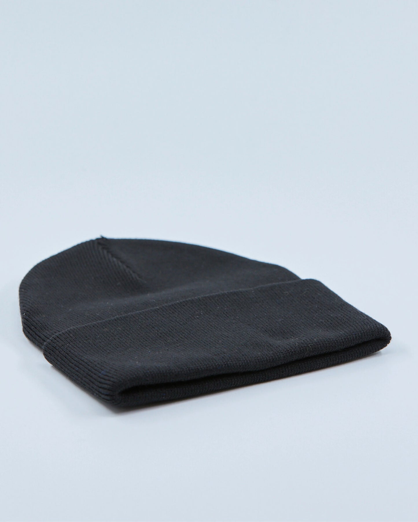 Black beanie on a light gray background
