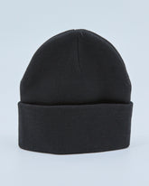 Black beanie on a light blue background