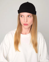 woman wearing a black docker cap