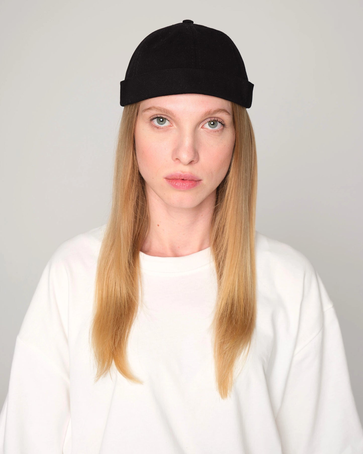 woman wearing a black docker cap