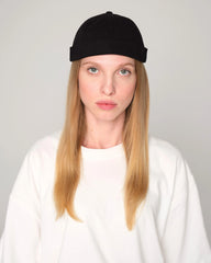 woman wearing a black docker cap
