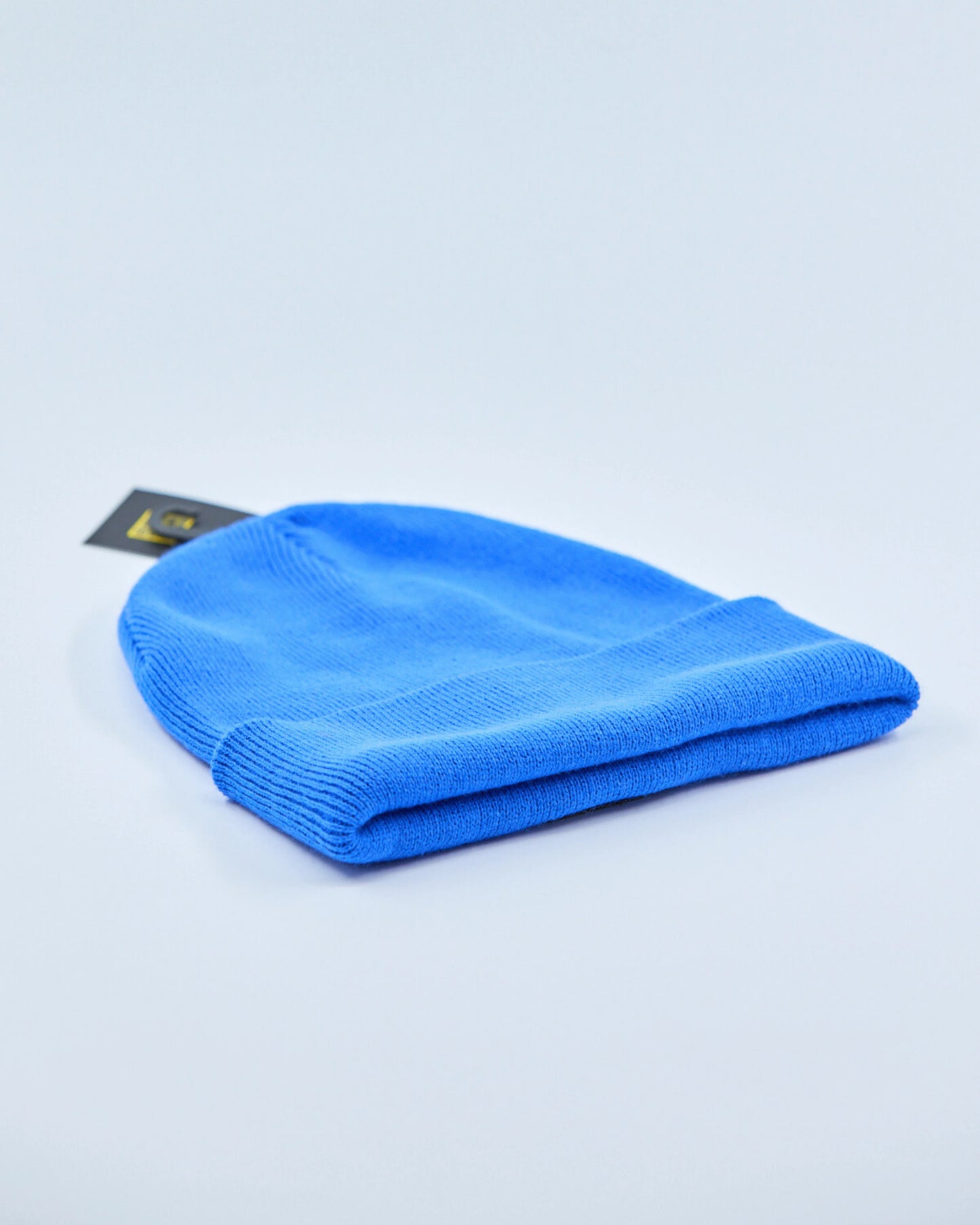 Bright blue beanie on a light gray background