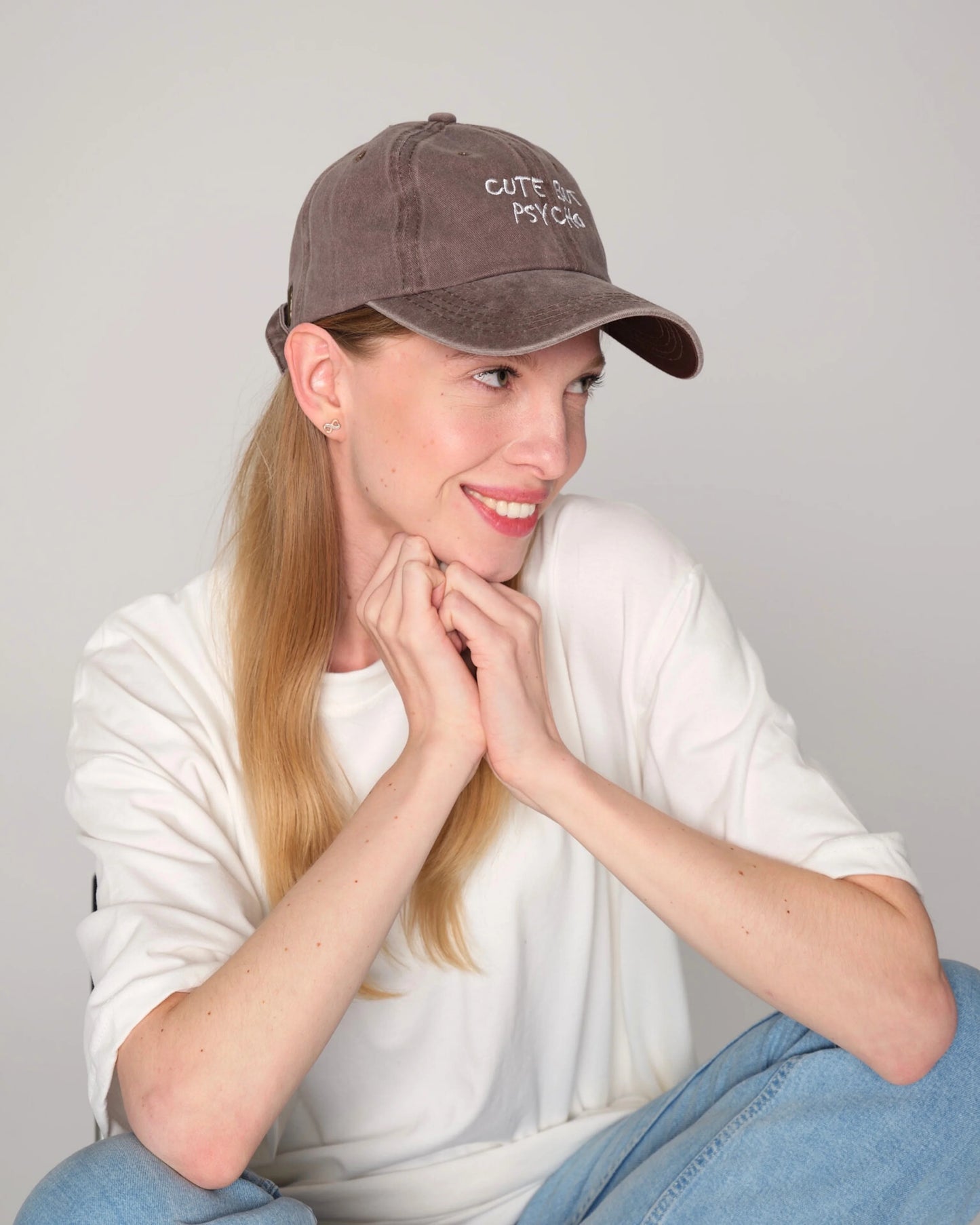 woman wearing Cute But Psycho Brown Washed Cap Hat