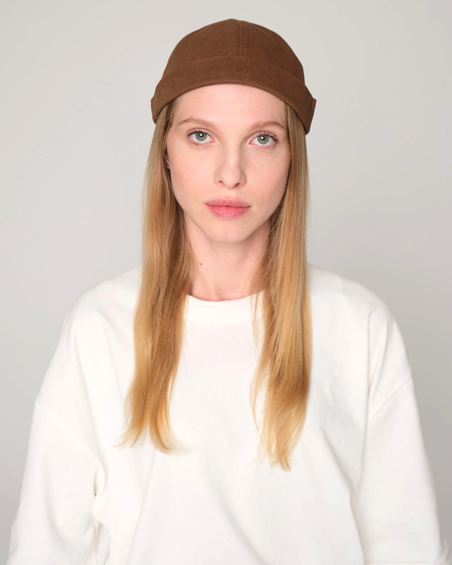 woman wearing brown docker cap hat