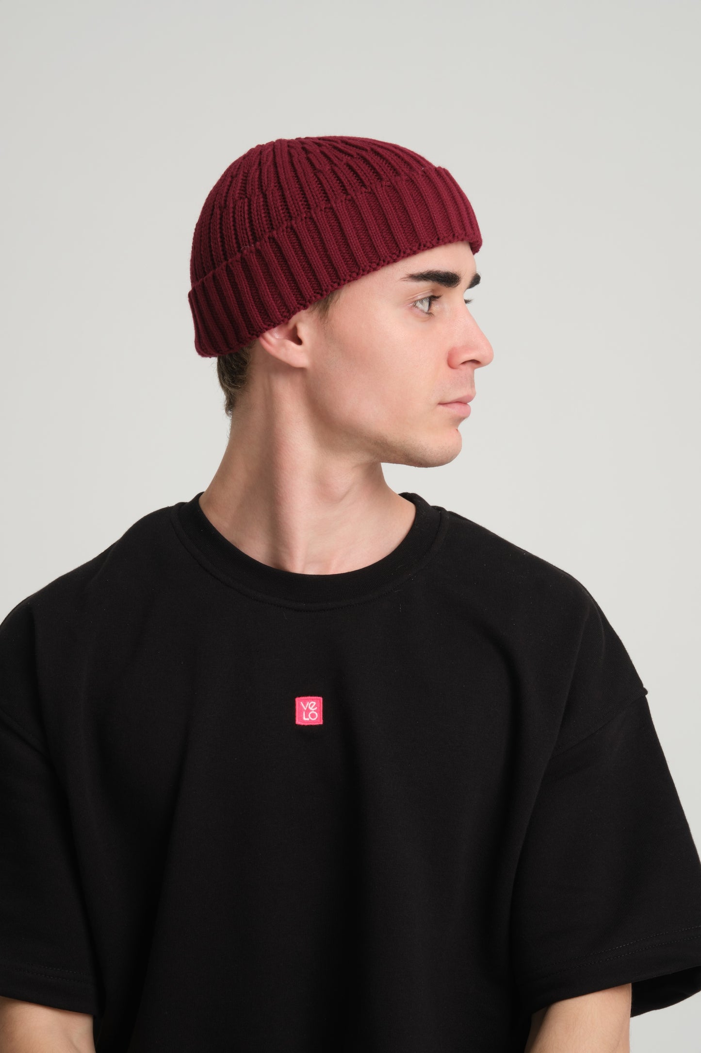 side view of a man wearing Burgundy Fisherman Beanie