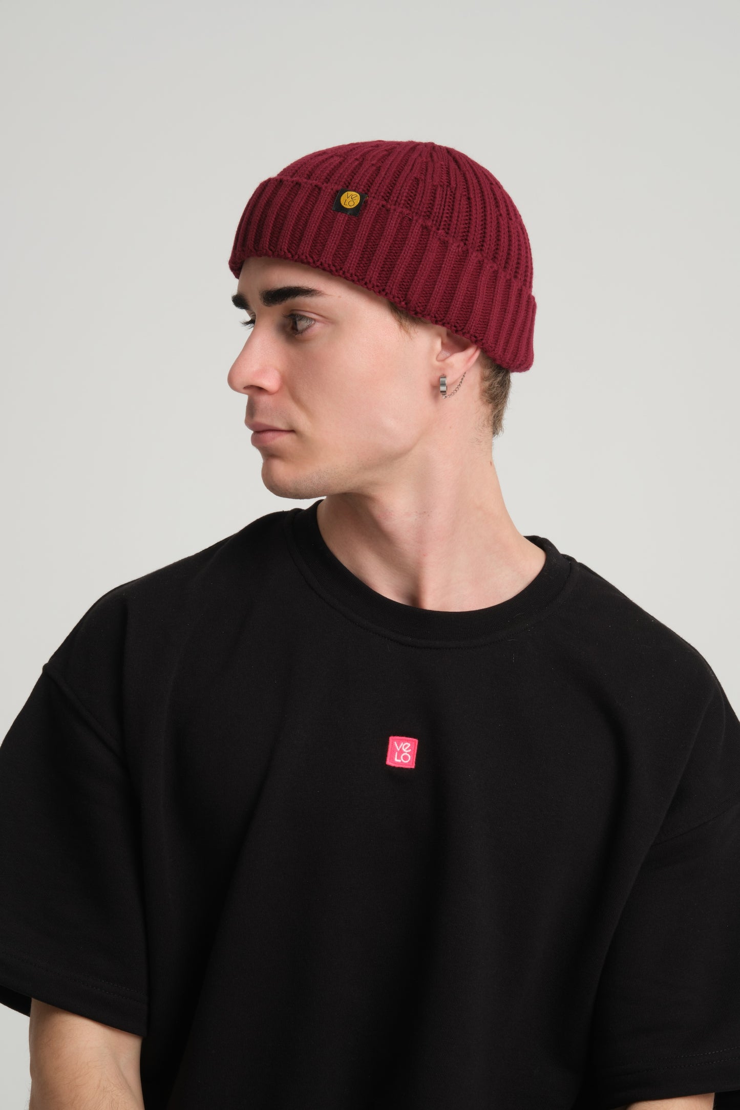 side view of a man wearing Burgundy Fisherman Beanie