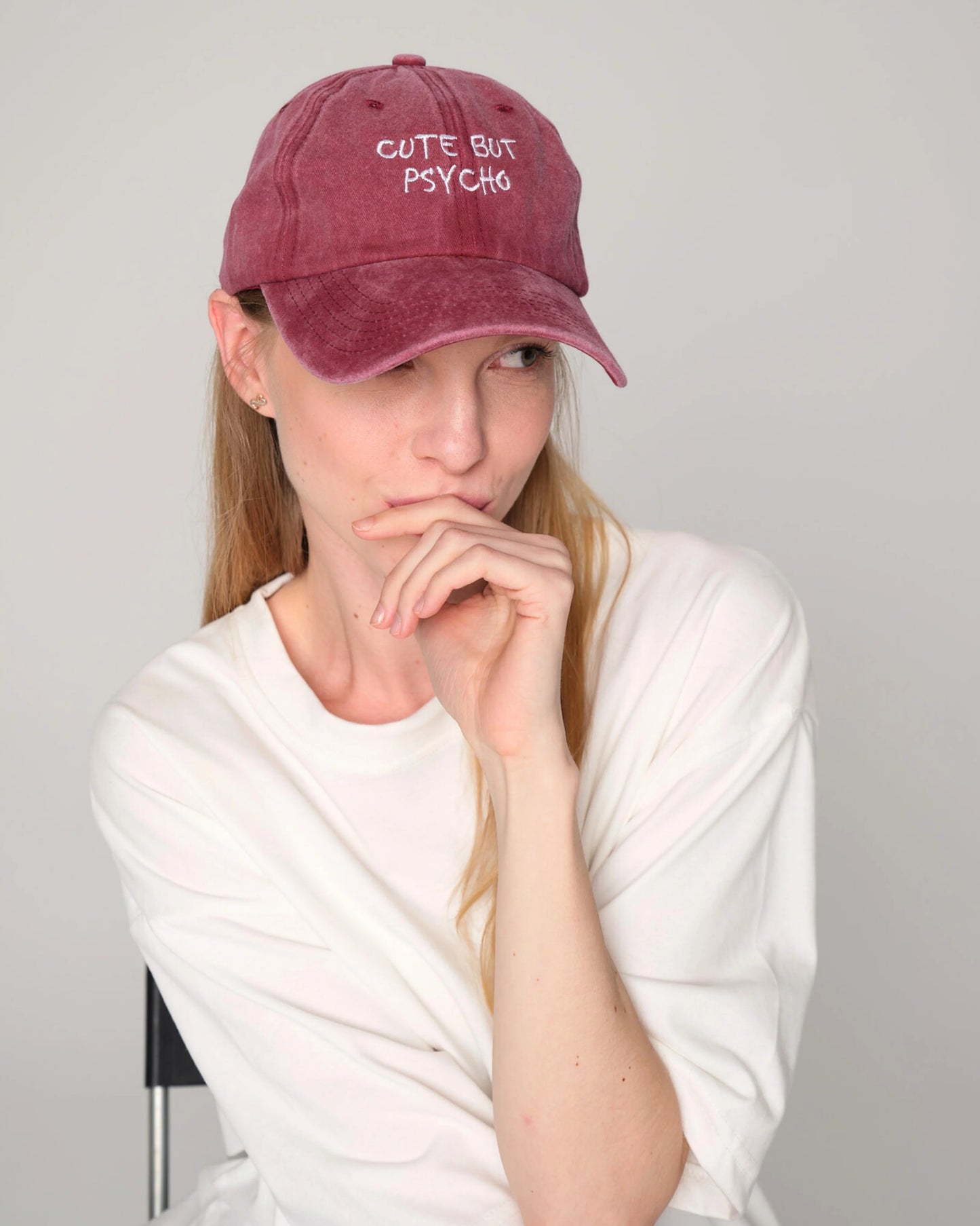 woman wearing Cute But Psycho Burgundy Washed Caps