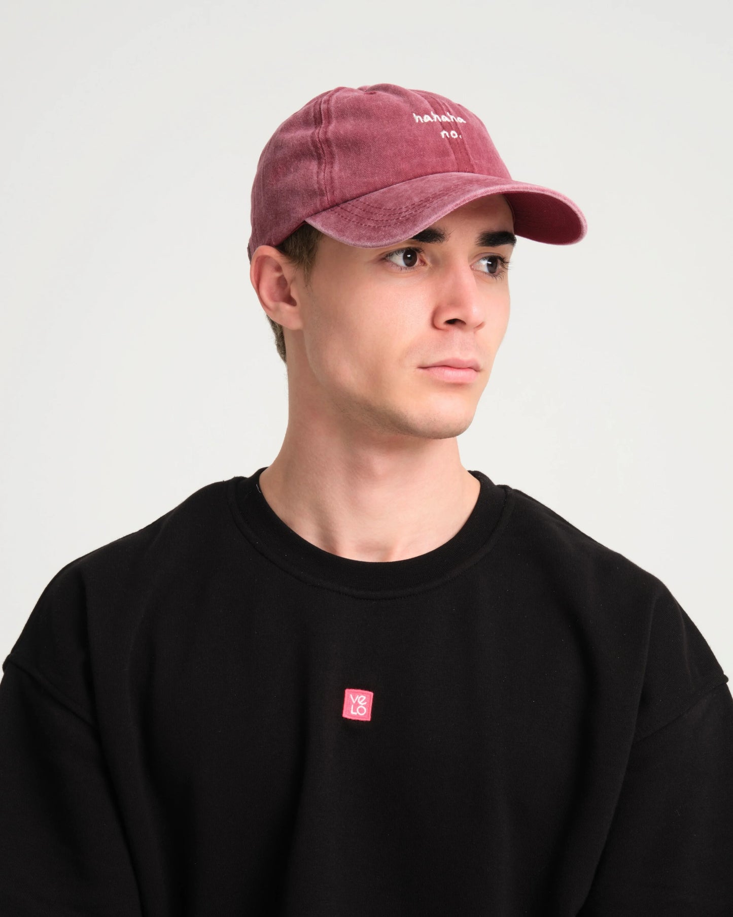 side view of man wearing Hahaha No Burgundy Washed Cap