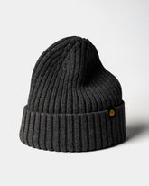 Charcoal Gray Classic Beanie with a gold tag on a light gray background