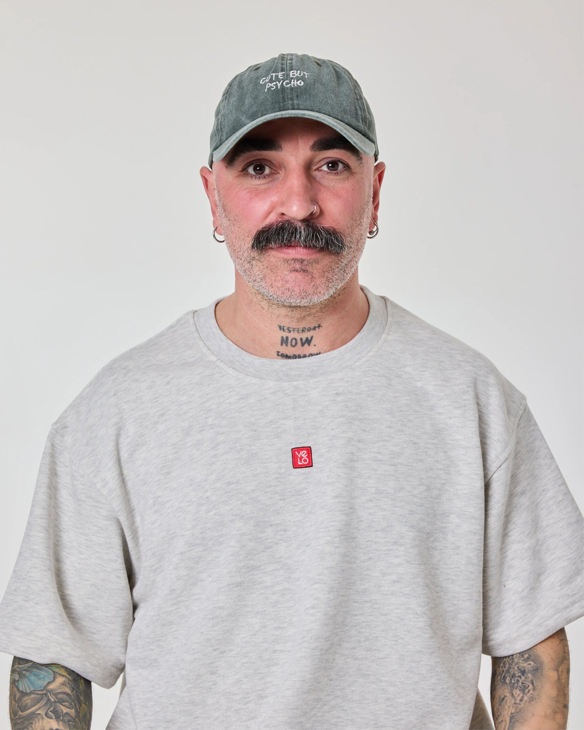 front view of a man wearing Cute But Psycho Dark Green Washed Cap