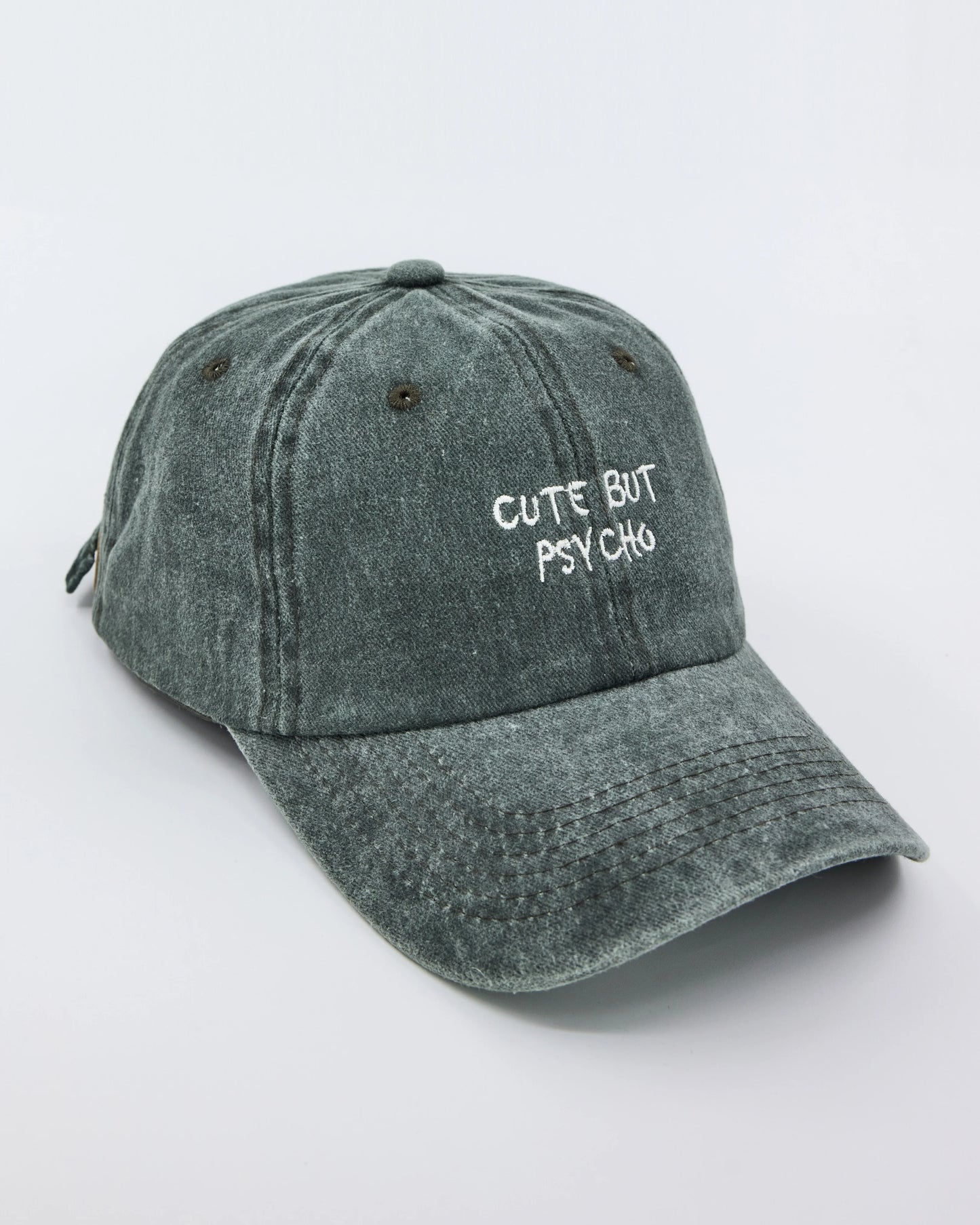 side view of Cute But Psycho Dark Green Washed Cap