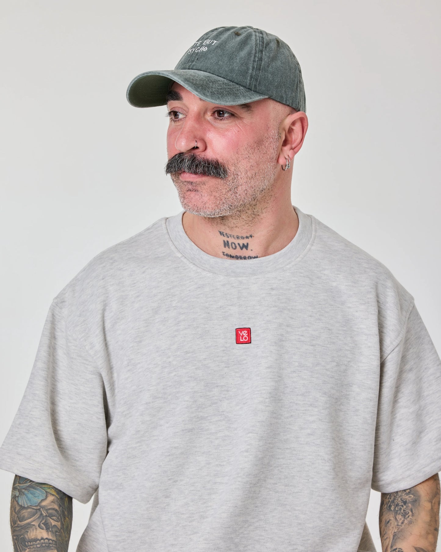 side view of a man wearing Cute But Psycho Dark Green Washed Cap