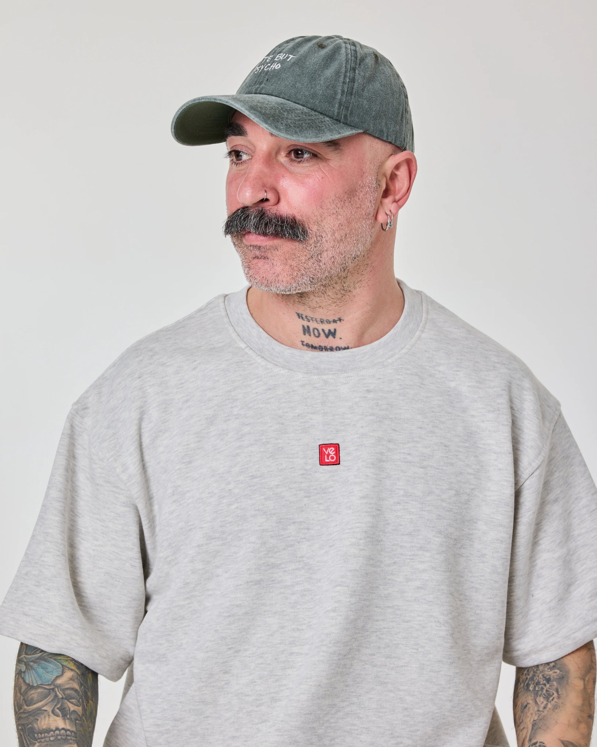side view of a man wearing Cute But Psycho Dark Green Washed Cap