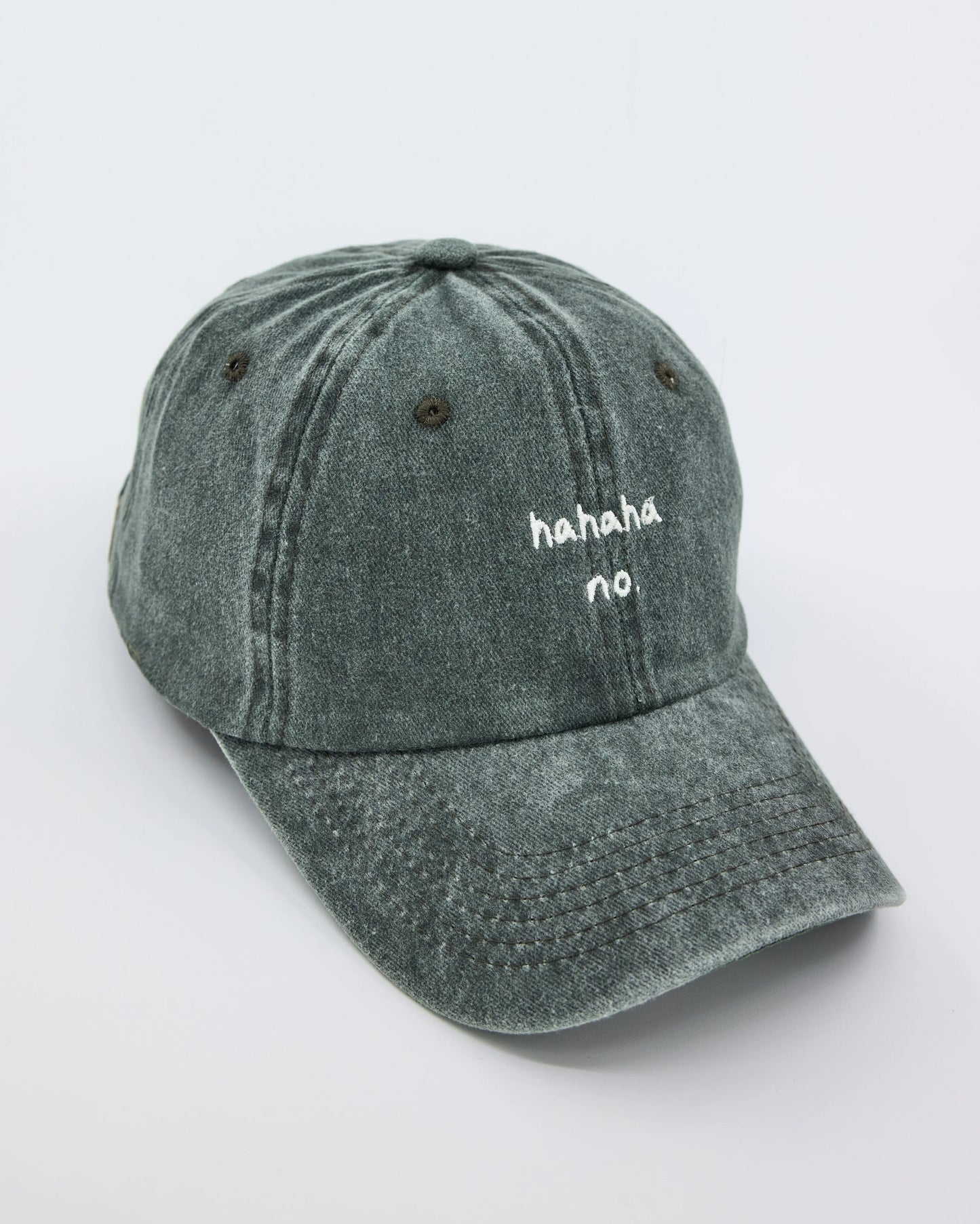 side view of Hahaha No Dark Green Washed Cap