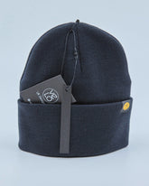 Navy blue beanie with a brand tag on a light gray background
