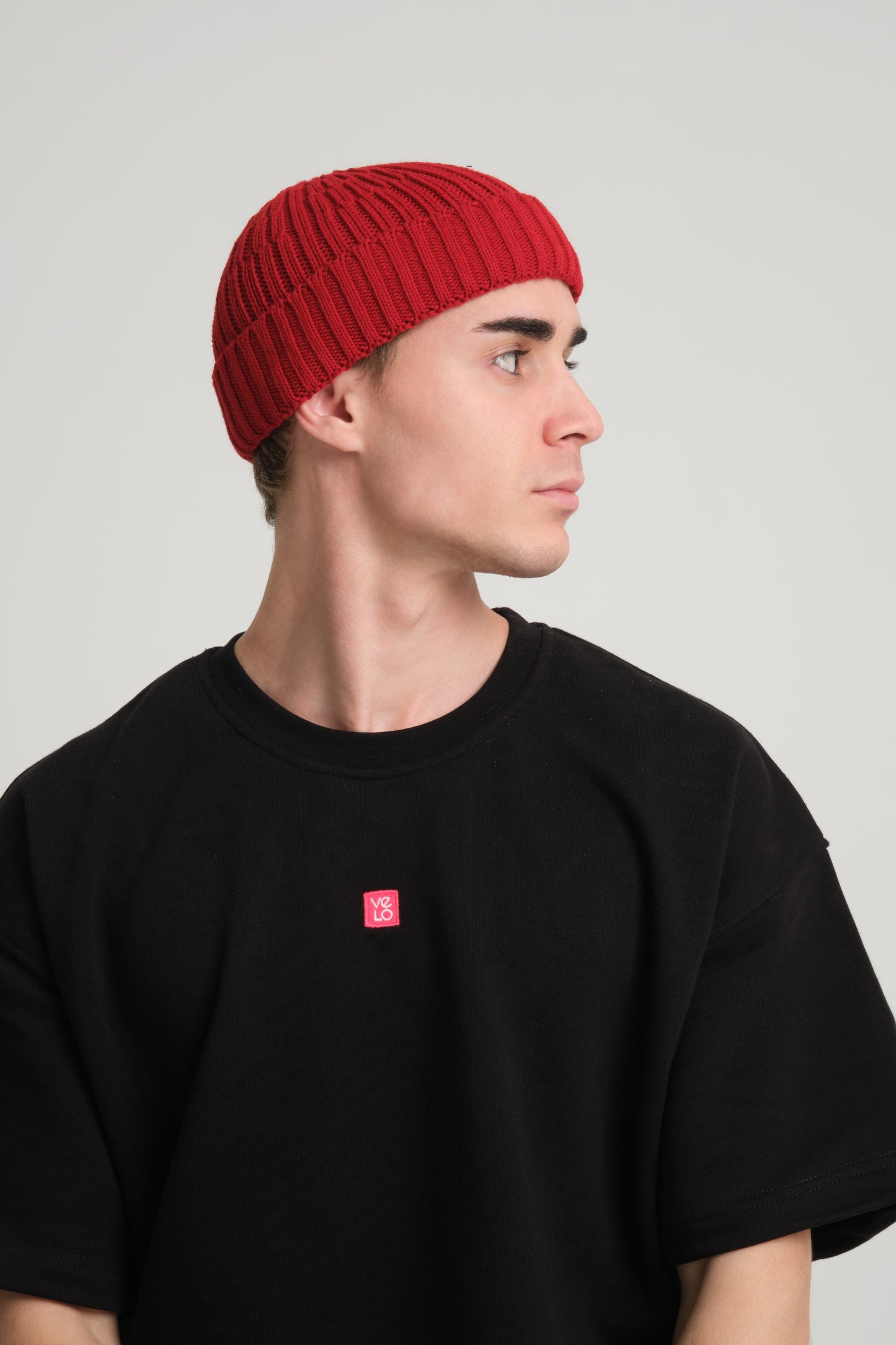 side view of a man wearing Chilli Red Fisherman Beanie