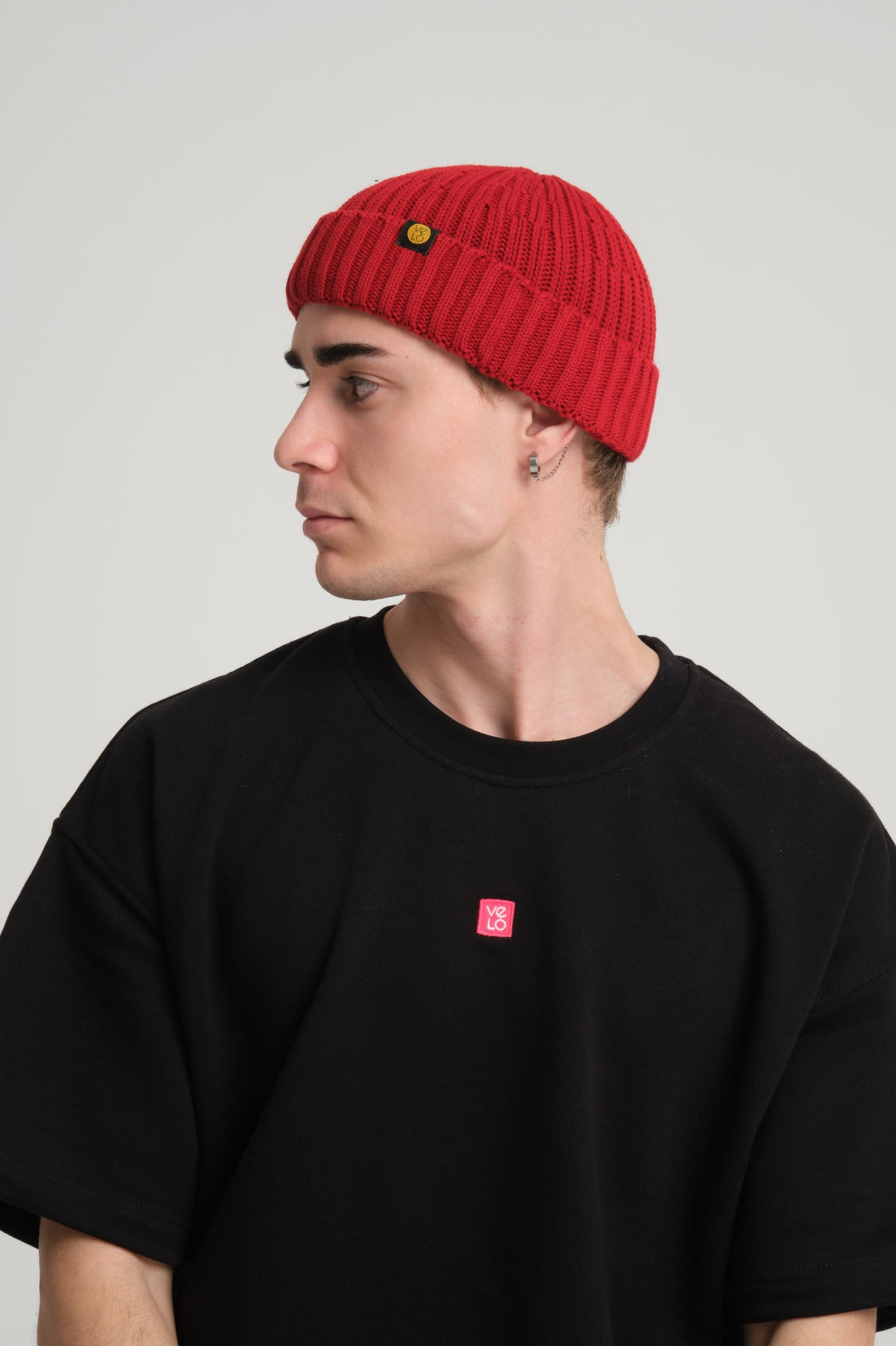 side view of a man wearing Chilli Red Fisherman Beanie