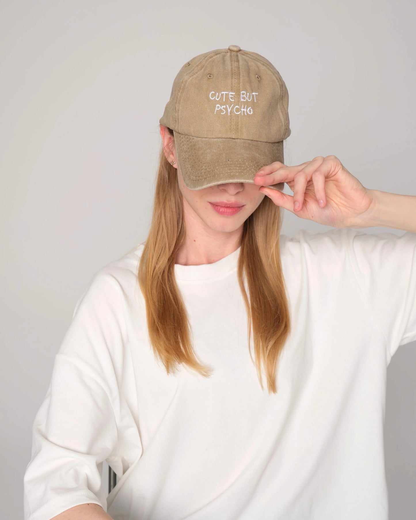 woman wearing Cute But Psycho Cream Washed Cap