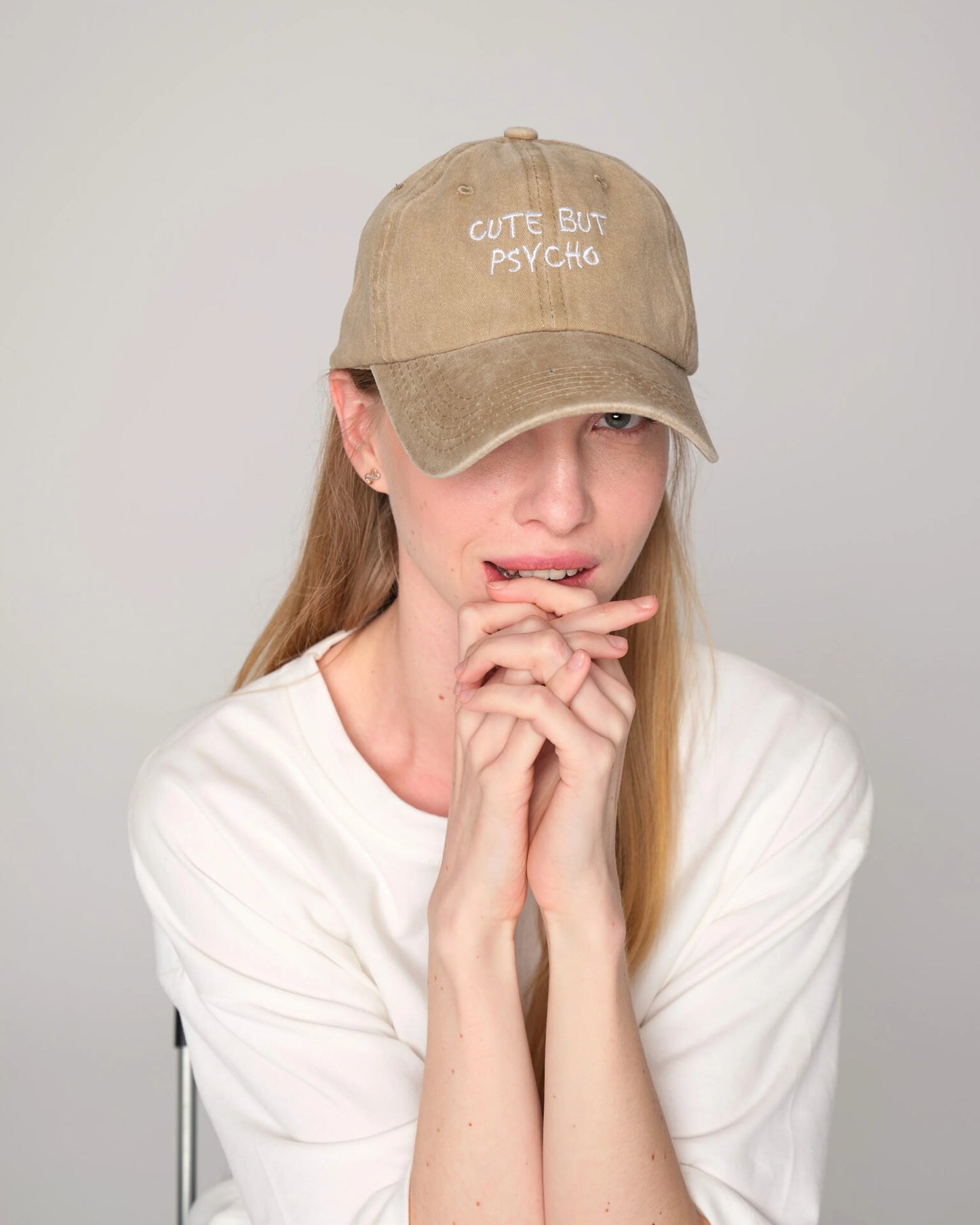 woman wearing Cute But Psycho Cream Washed Cap Hat