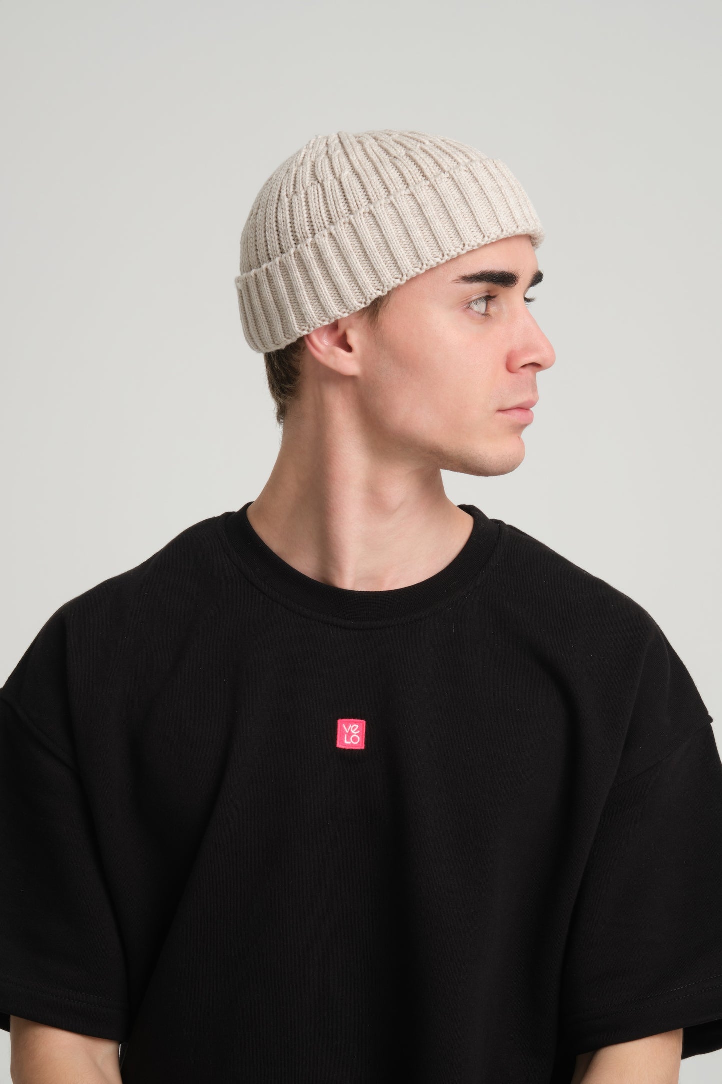 side view of a man wearing Cream Fisherman Beanie