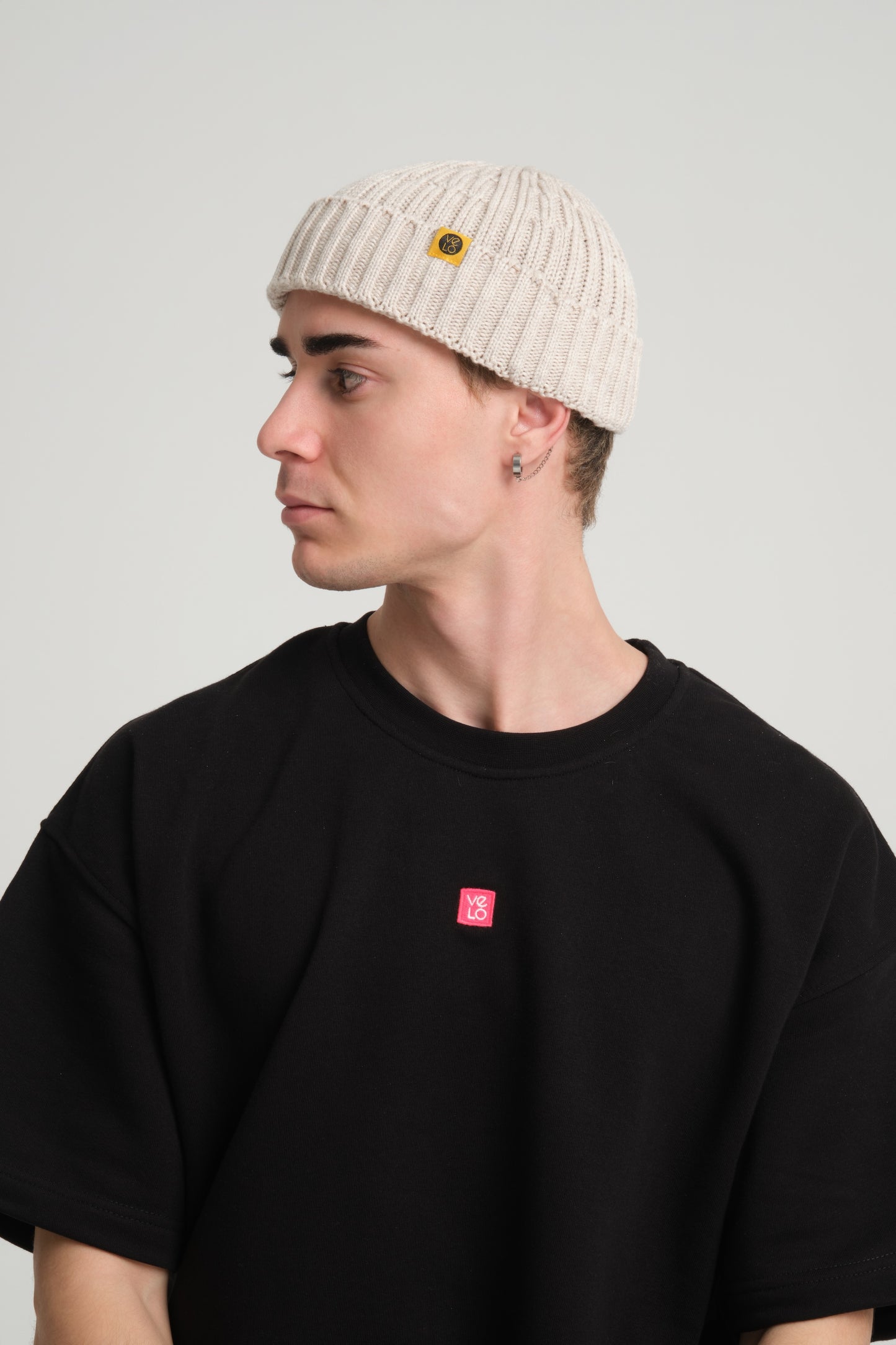side view of a man wearing Cream Fisherman Beanie