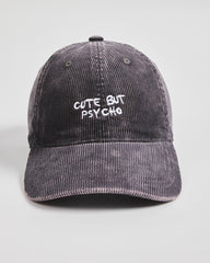 Gray corduroy cap with 'Cute But Psycho' text on a light gray background