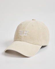 Cream corduroy cap with text on a light gray background