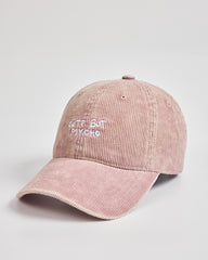 Pink cap with 'Cute But Psycho' text on a light gray background