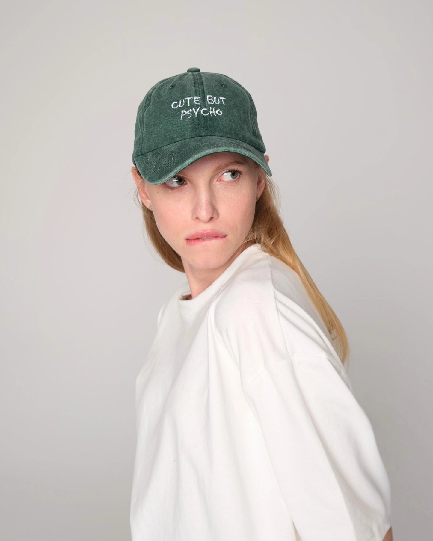 female model wearing cute but psycho green washed cap