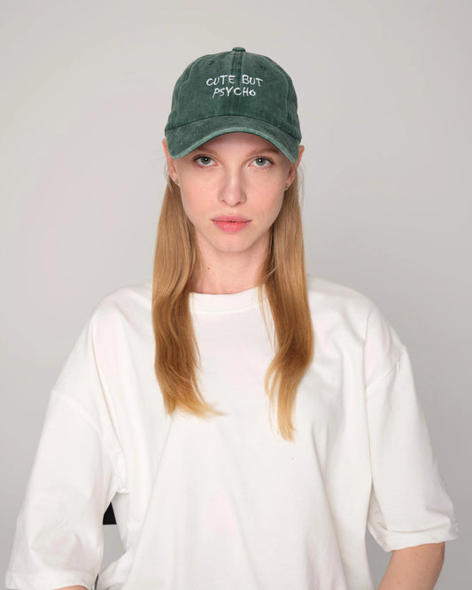 Front look of female model wearing cute but psycho green washed cap