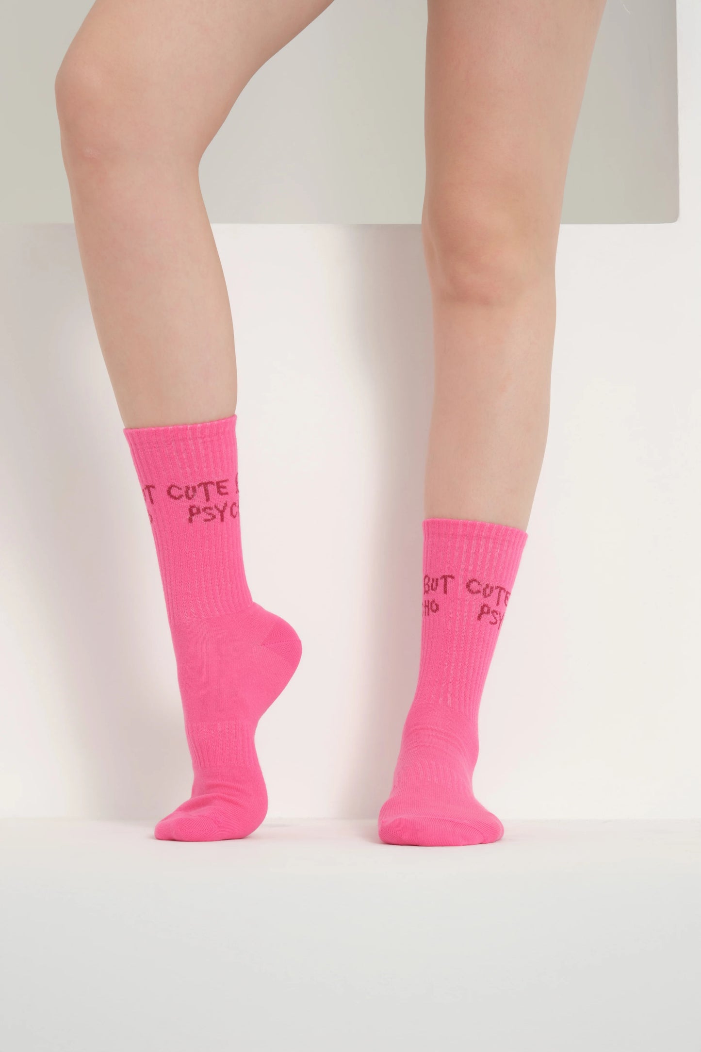 front view of a hot pink cute but psycho socks