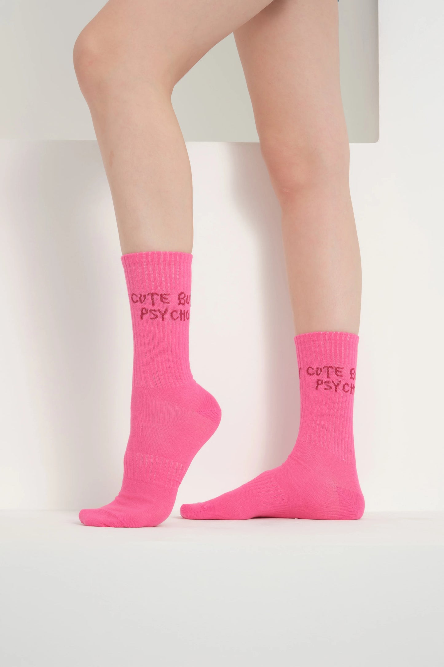 side view of a hot pink cute but psycho socks