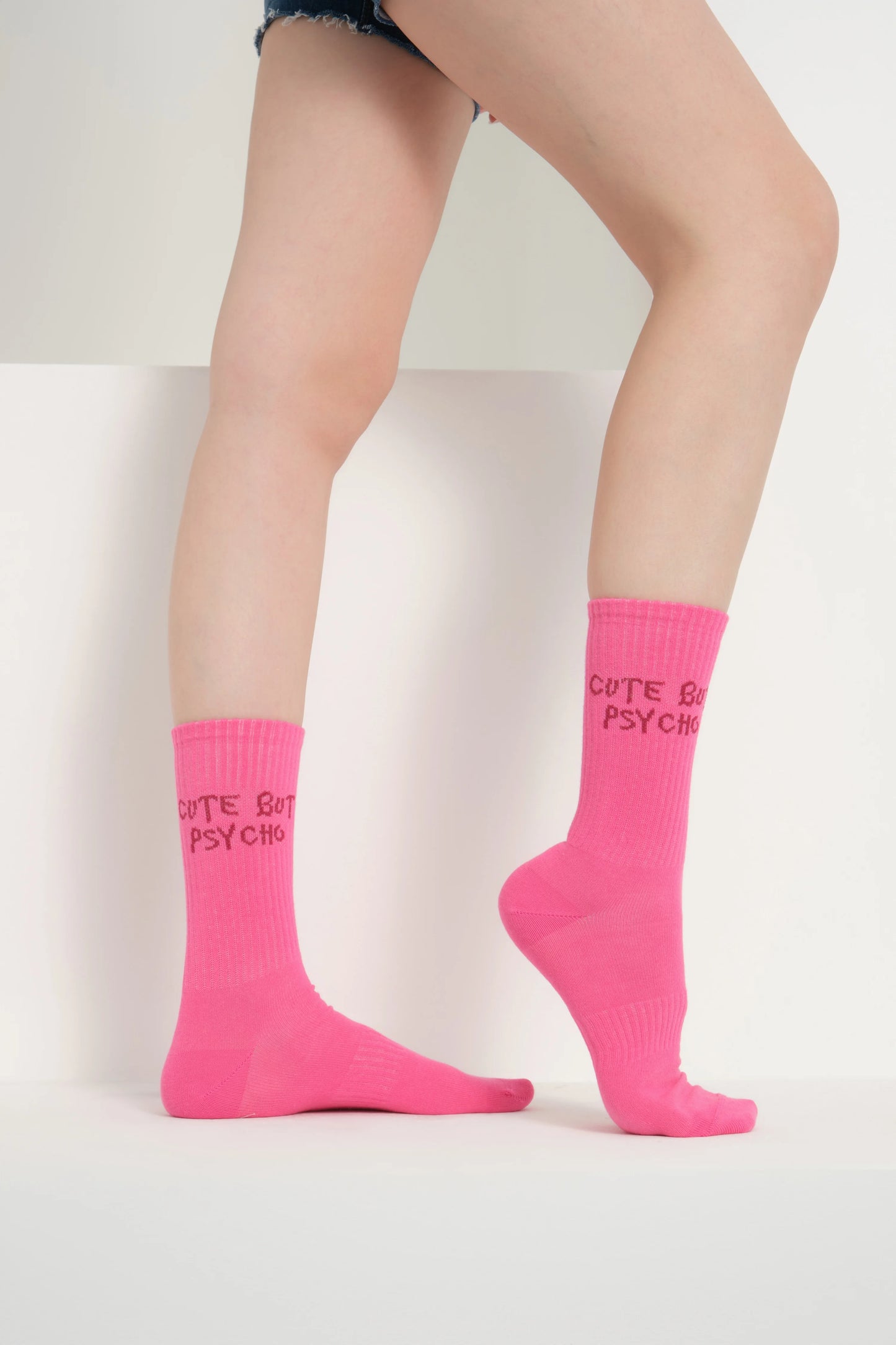 side view of a hot pink cute but psycho socks