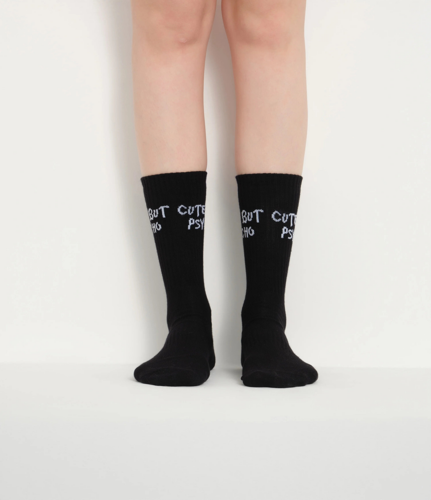 front view of black cute but psycho socks