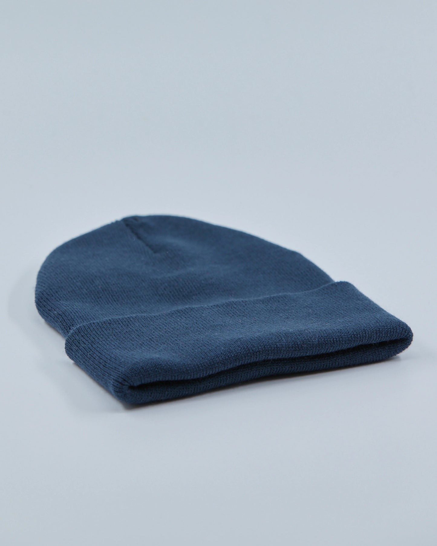 Dusty navy beanie on a light gray background