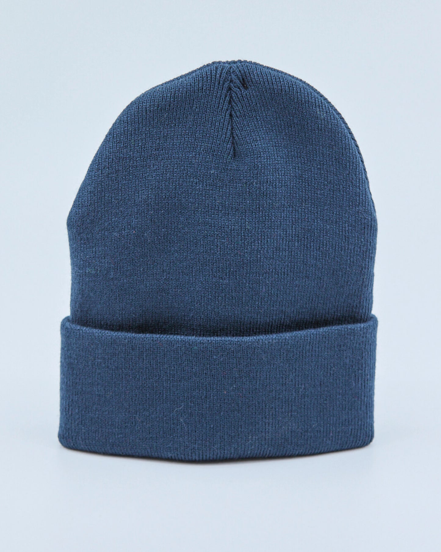 Dusty navy blue beanie on a light blue background