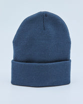Dusty navy blue beanie on a light blue background