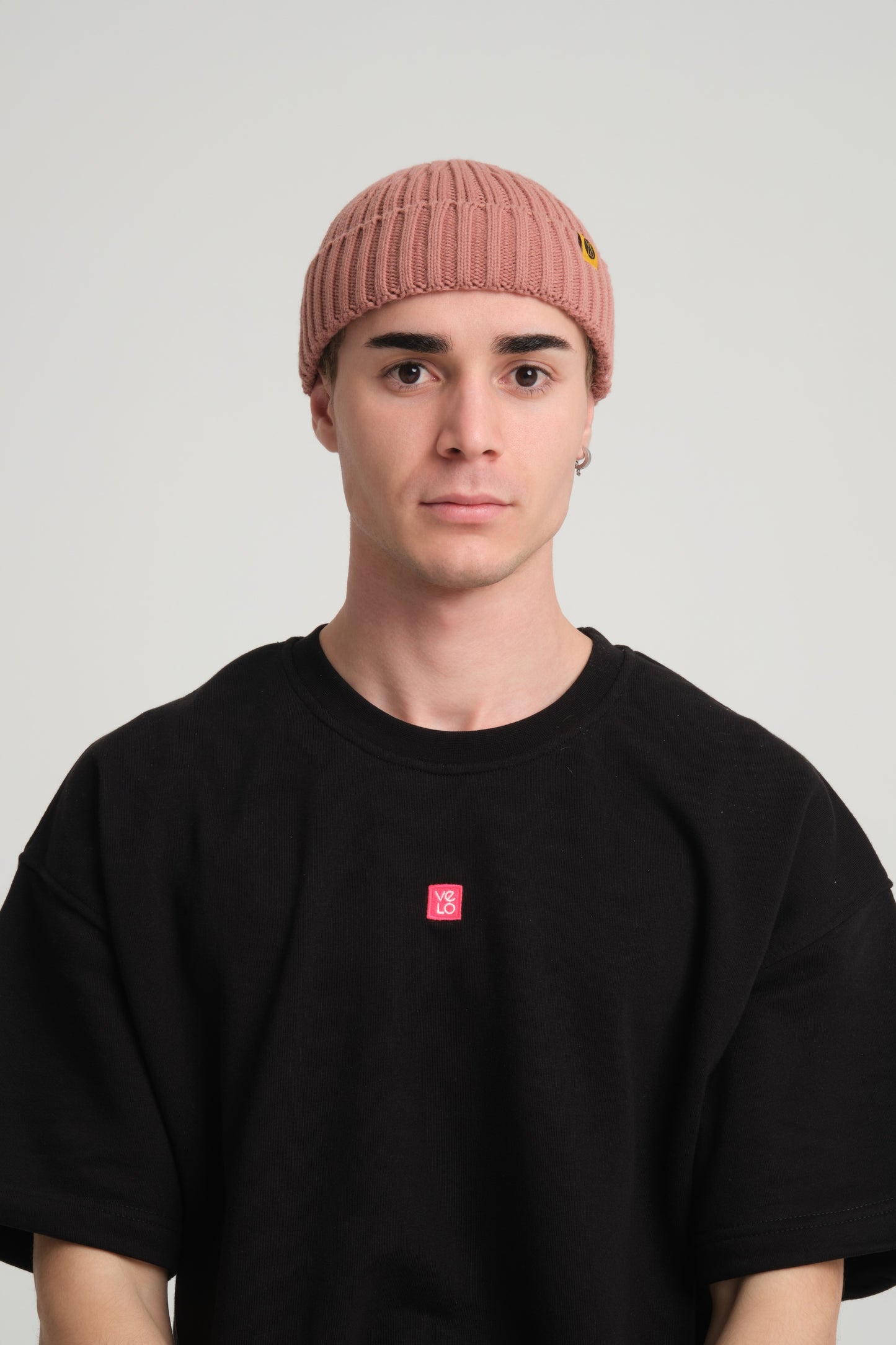 front view of a man wearing Dusty Pink Fisherman Beanie