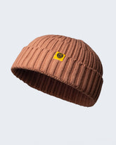 dusty pink fisherman beanie on a white background