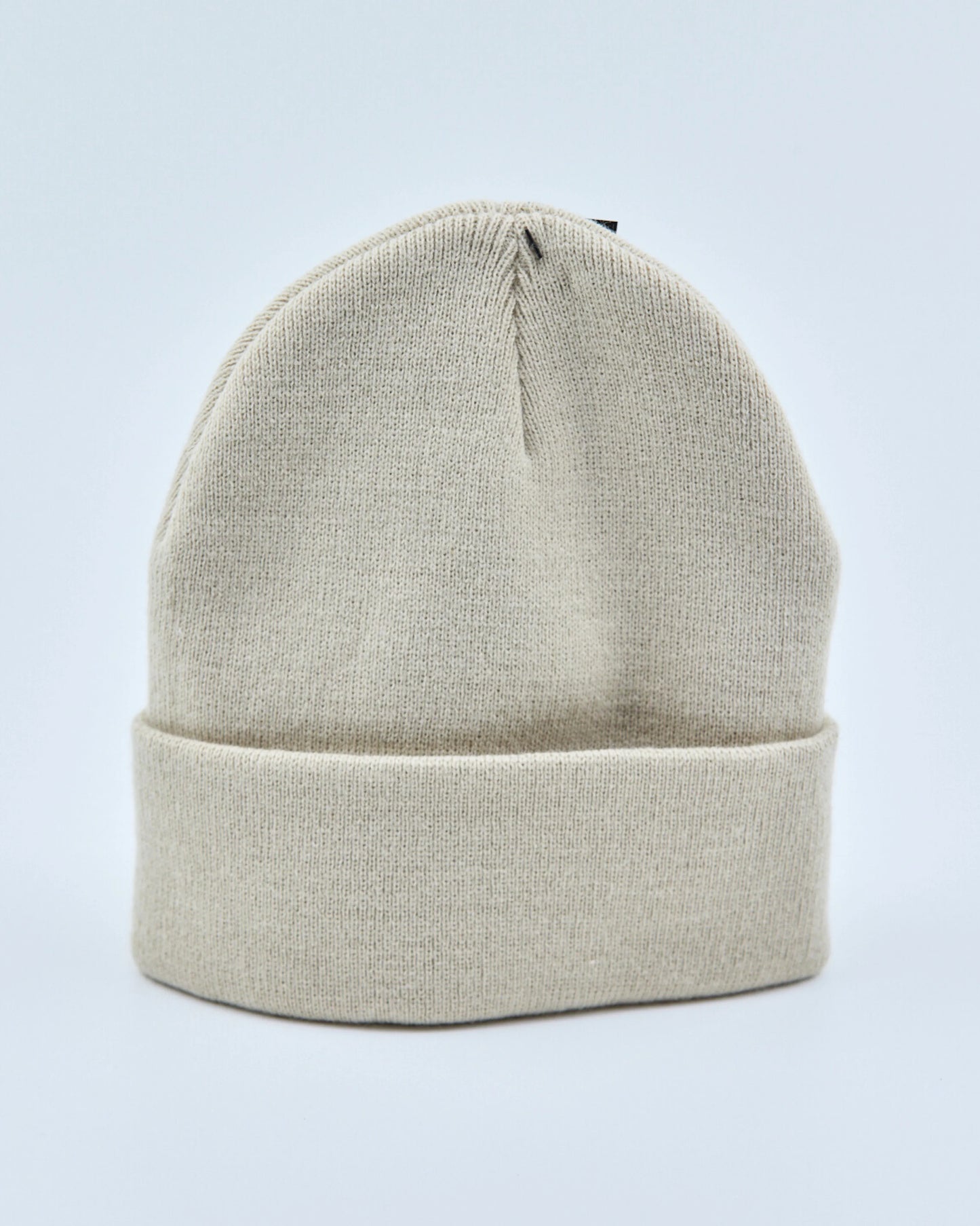 Ecru white beanie on a light gray background