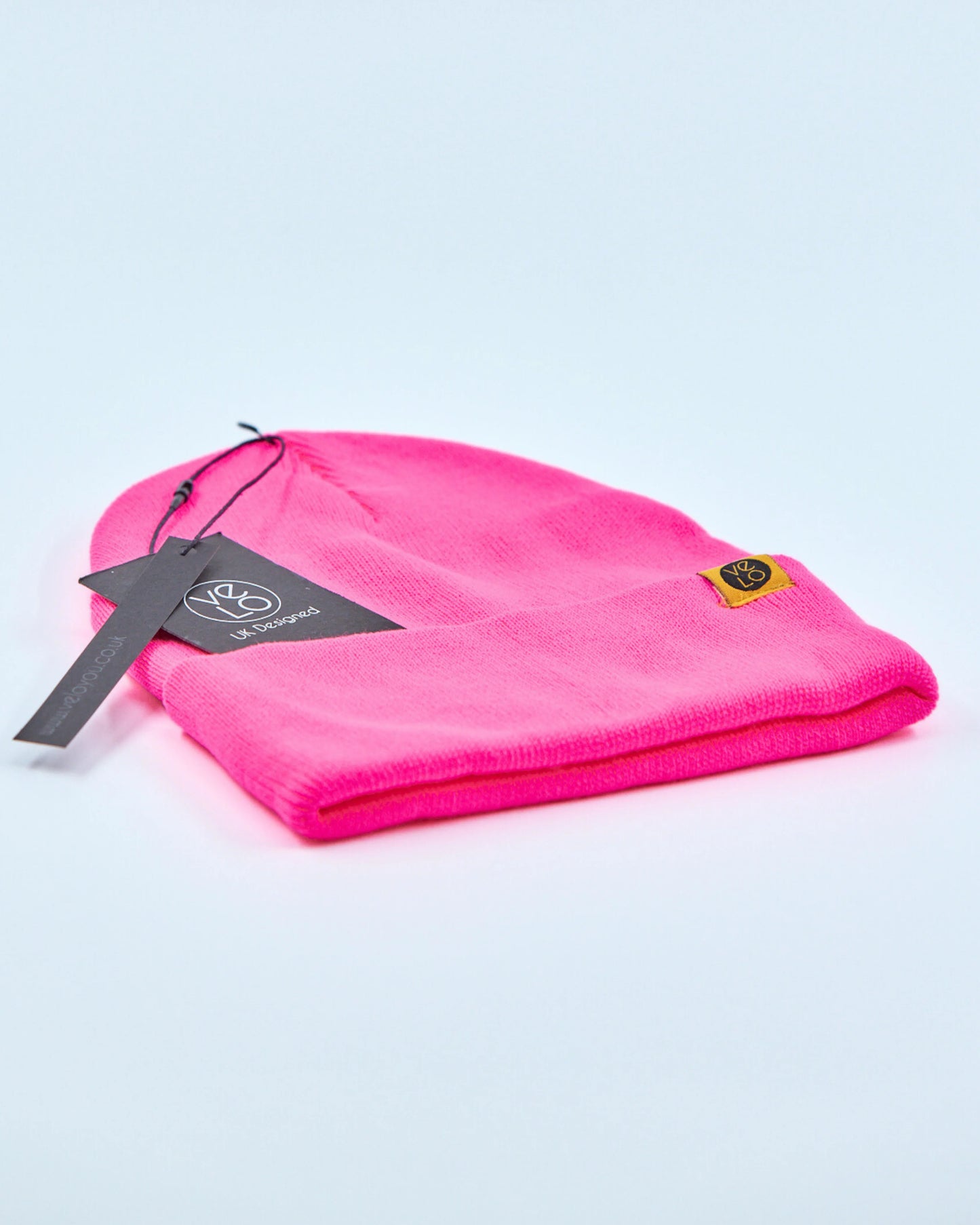 Fuschia pink beanie on a light gray background
